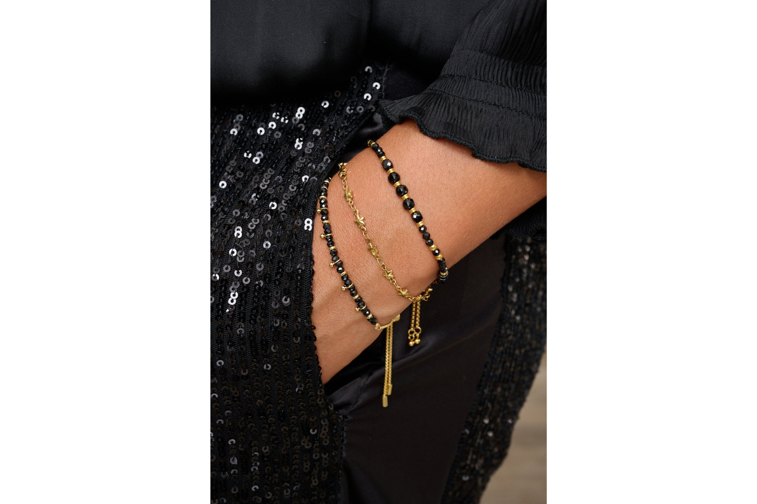 Alina Gold Star Chain Slider Bracelet styled on the wrist with layered Boho Betty star and gold stacking bracelets.