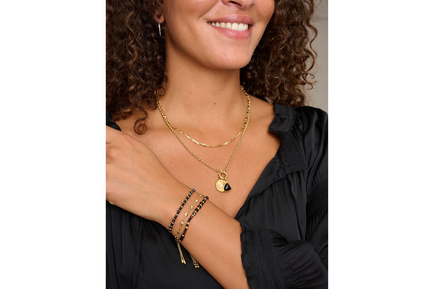 Alina & Solara gold star bracelet and necklace set layered with gold jewelry, styled on wrist and neckline – Boho Betty