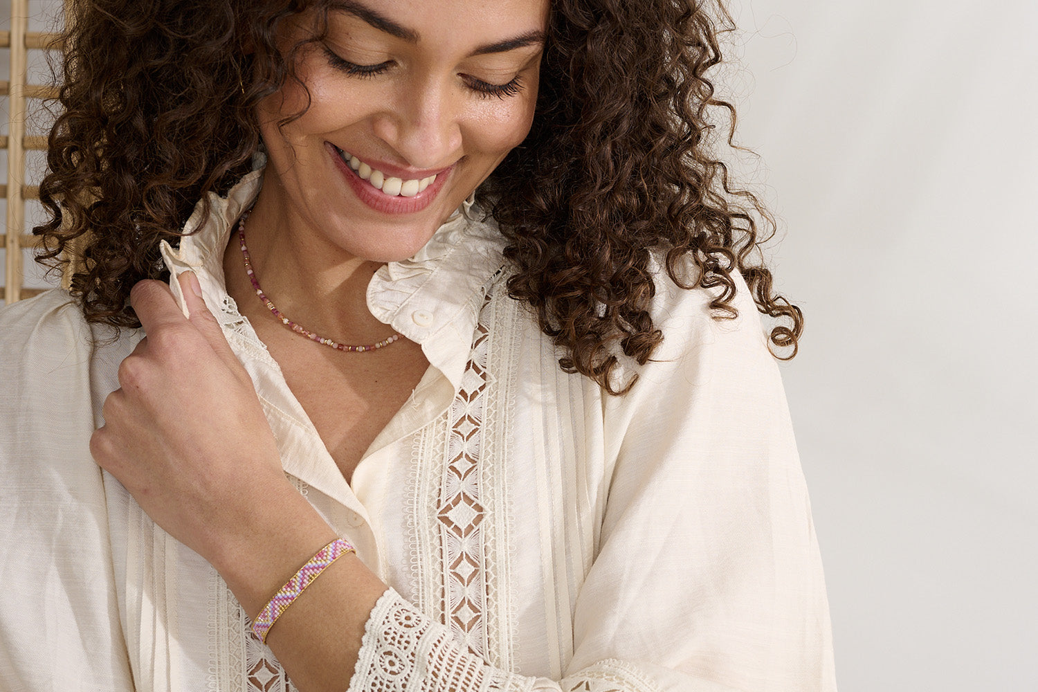 Claudia Pink Gold Friendship Bracelet styled on the wrist, showcasing a feminine mix of pink, lilac, and gold beads, perfect for layering or wearing solo.