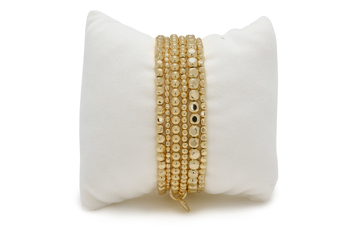 Eleora Gold Bracelet Stack featuring six PVD gold stainless steel bracelets with a mix of polished and textured beads.