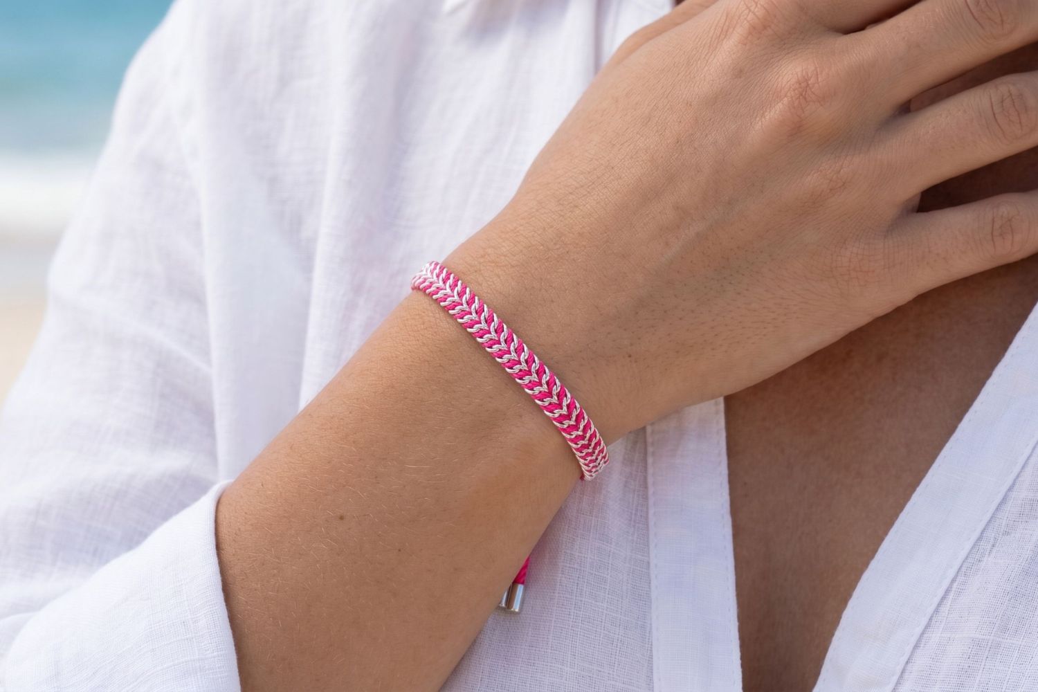 Iztac Silver & Hot Pink Woven Bracelet styled on the wrist with hot pink woven detailing and cool silver accents for bold boho stacking.