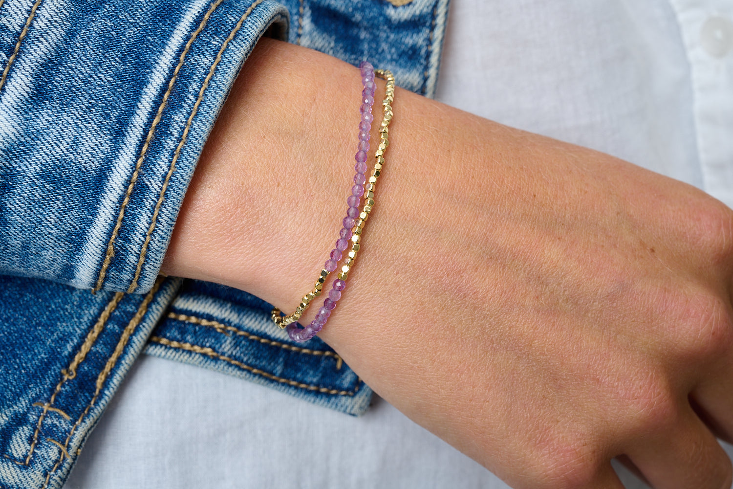 Juniper Gold & Amethyst Double Strand Bracelet styled with faceted purple gemstones and golden accents in a boho bracelet stack.