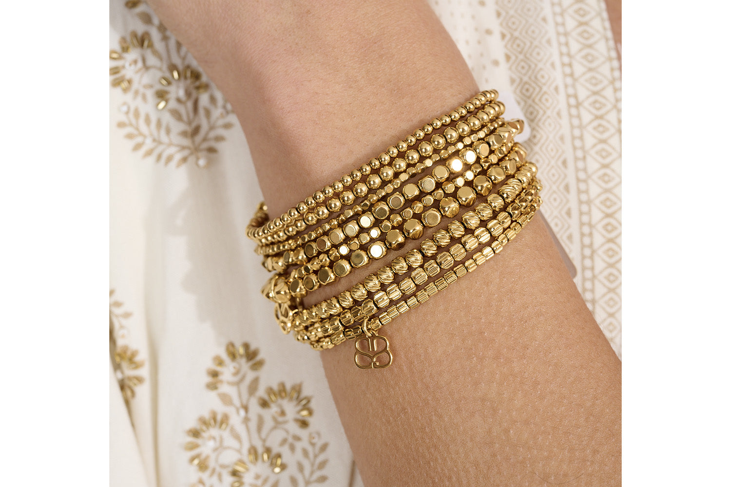 Kamala Minor Gold Stretch Bead Bracelet Set styled with layered gold jewelry, showcasing delicate beadwork and effortless stacking versatility.