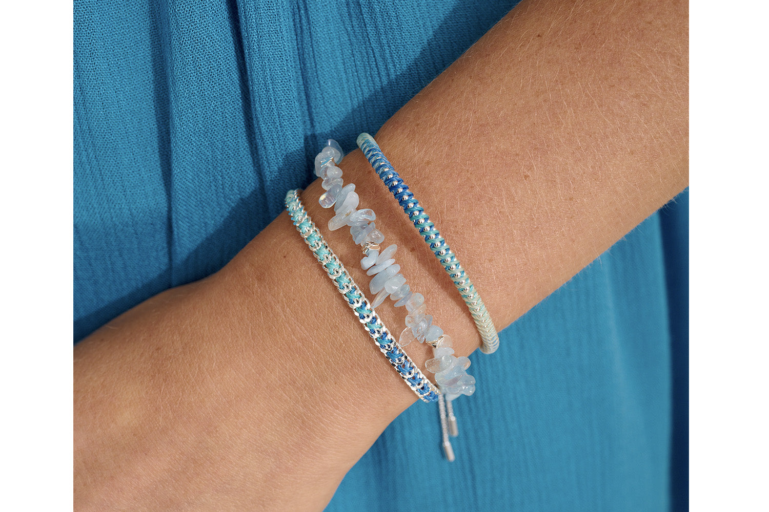 Lilia Blue & Silver Ombre Cord Bracelet styled on wrist, showcasing ocean hues and shimmering silver chain, perfect for summer layering.
