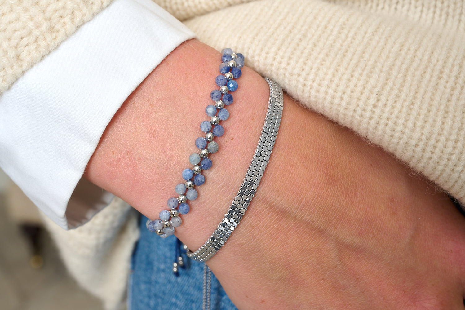 Marisol Blue Aventurine & Silver Gemstone Bracelet styled on the wrist with layered silver and blue gemstone bracelets.