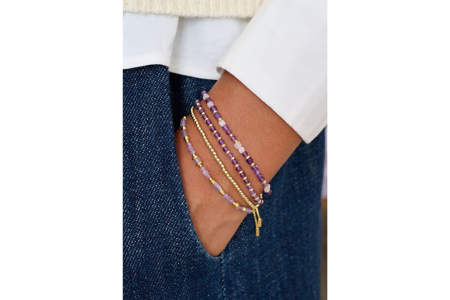 Salma Amethyst Bracelet styled on wrist with gold boho stacking bracelets and soft-toned fashion for a peaceful, feminine look.