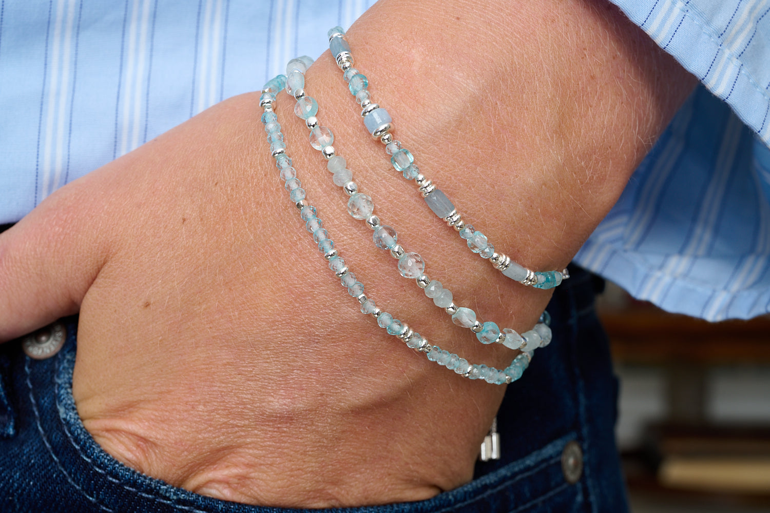 Salma Blue Topaz & Silver Friendship Bracelet featured on wrist with Boho Betty stacking bracelets in silver and blue gemstone tones.