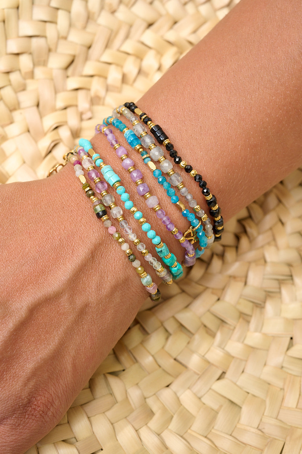 Yasmin Labradorite Bracelet styled in a layered stack of boho bracelets for a modern, earthy look with gold accents.
