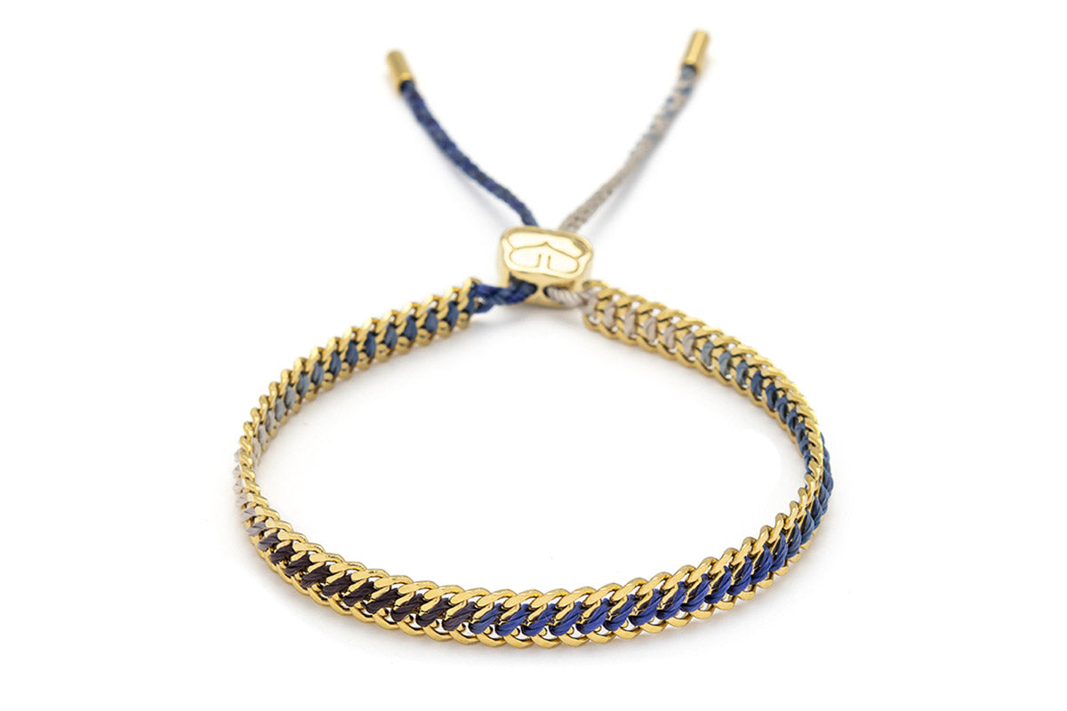 Athena Denim Gold Braided Bracelet with blue ombré thread woven through 14k gold PVD curb chain, perfect for effortless beachy boho style.