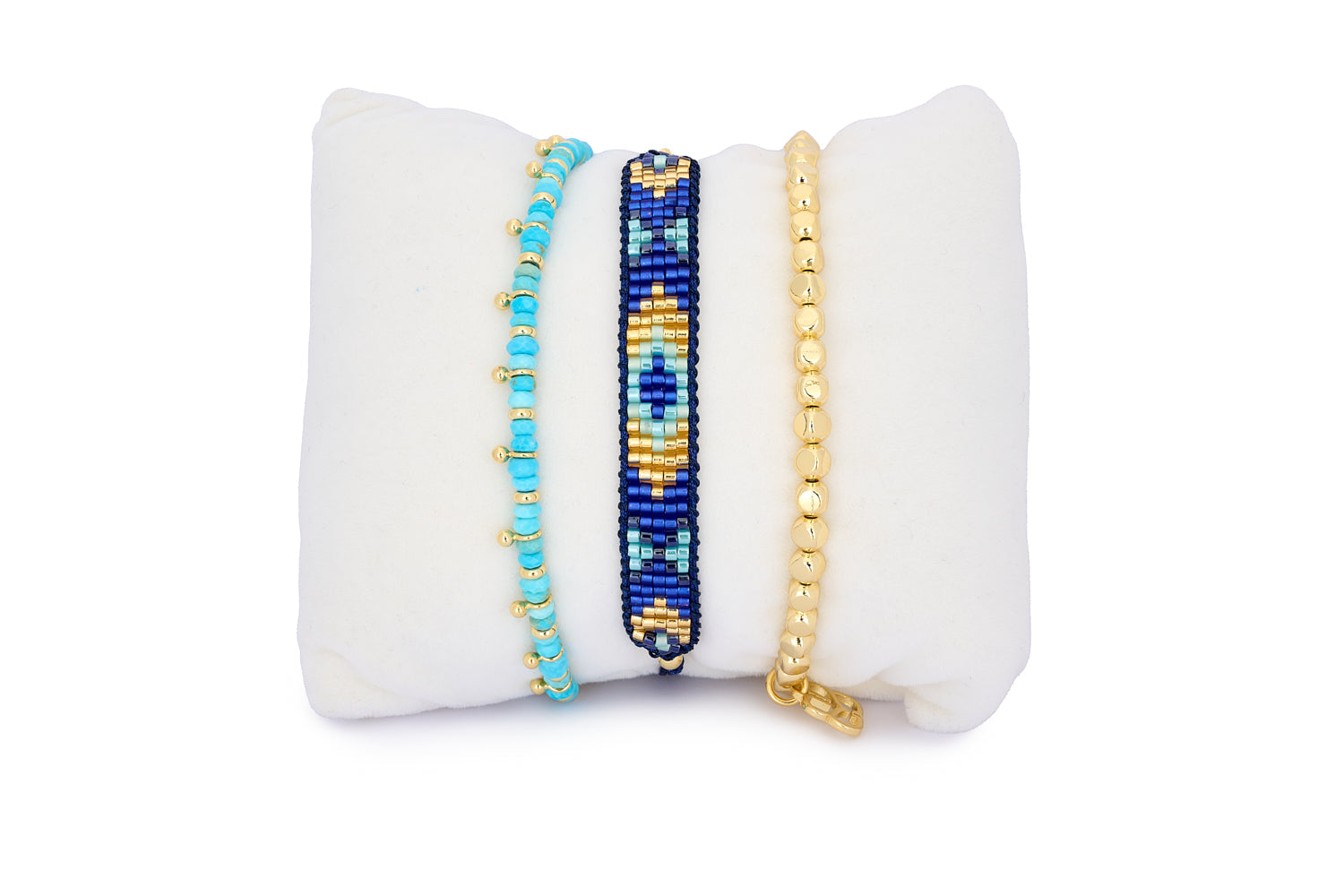 Bali Turquoise Howlite & Gold Bracelet Stack featuring a trio of bracelets with turquoise howlite beads, royal blue woven thread, and polished gold nugget accents.
