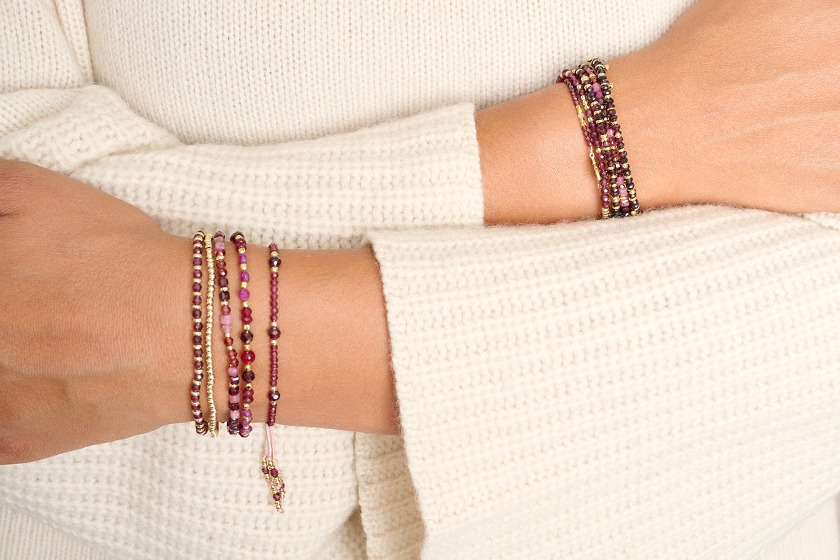 Laria garnet January birthstone bracelet featured on wrist with Boho Betty stacking bracelets
