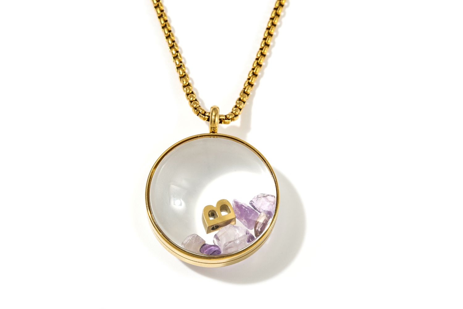 Leilani Personalised Gold Locket Necklace featuring Amethyst chips and an engraved initial charm inside a glass fillable pendant on a gold chain.