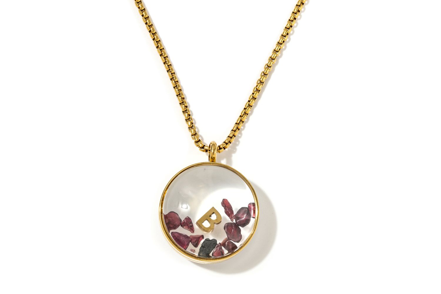 Leilani Personalised Gold Locket Necklace featuring Garnet chips and an engraved initial charm inside a glass fillable pendant on a gold chain.