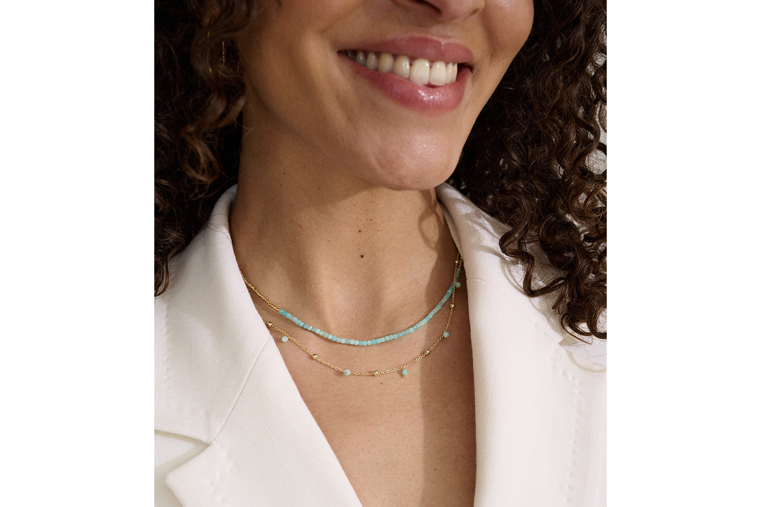 Lily Amazonite & Gold Necklace styled on the neckline, showcasing its layered gold chains and aqua gemstones—perfect for a relaxed boho-chic look.