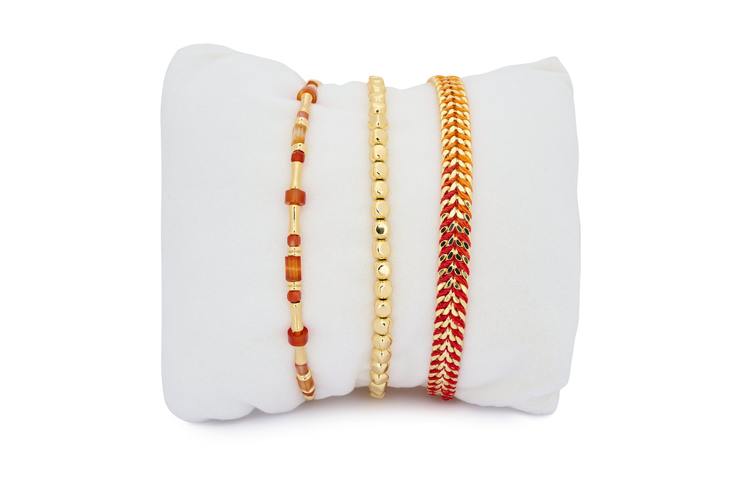 Makatea Gold & Orange Agate Bracelet Stack featuring three radiant bracelets with orange agate beads, gold accents, and woven ombré threads.