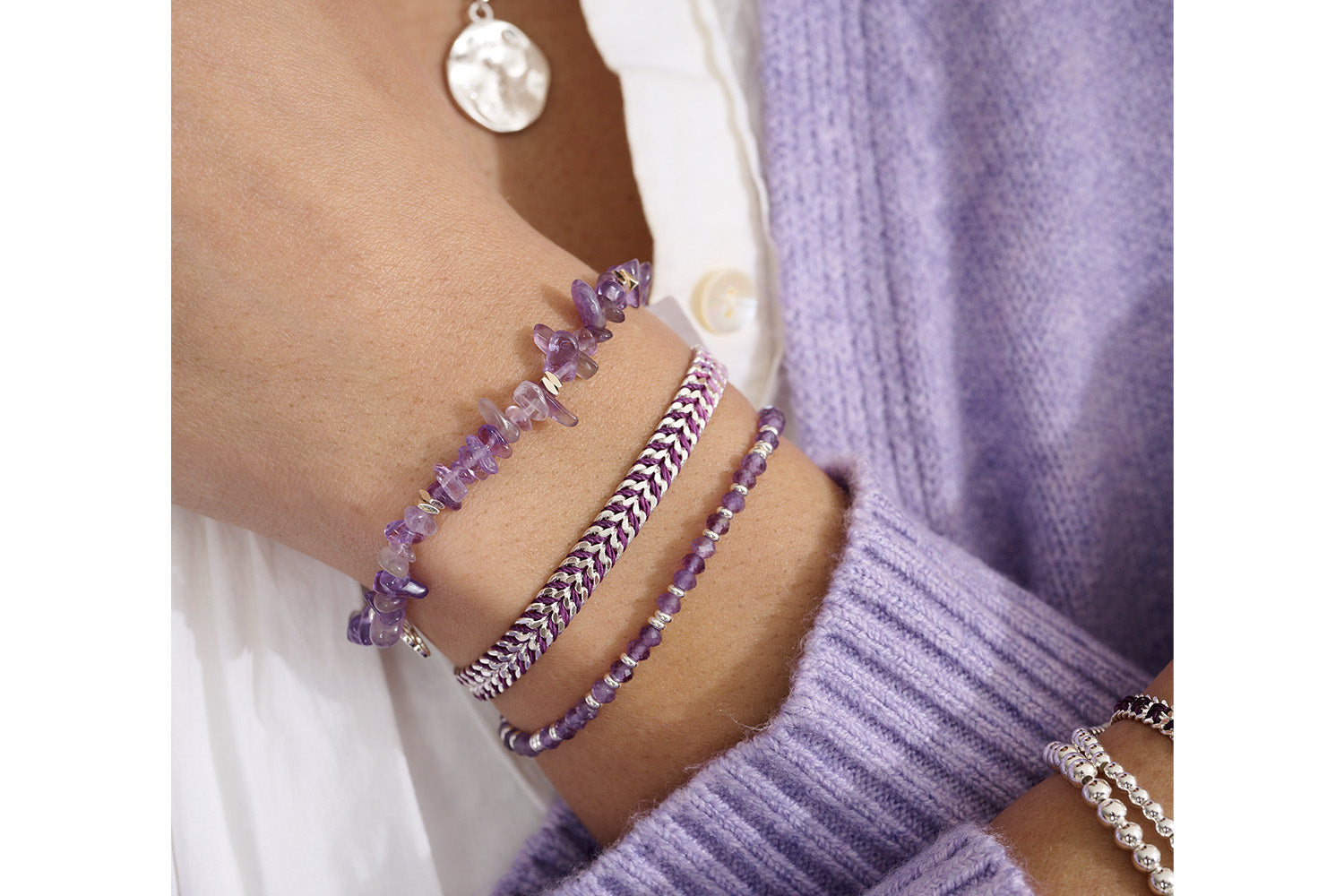 Maupiti Silver & Amethyst Bracelet Stack styled with soft fabrics and layered silver jewellery for a calming, celestial look.