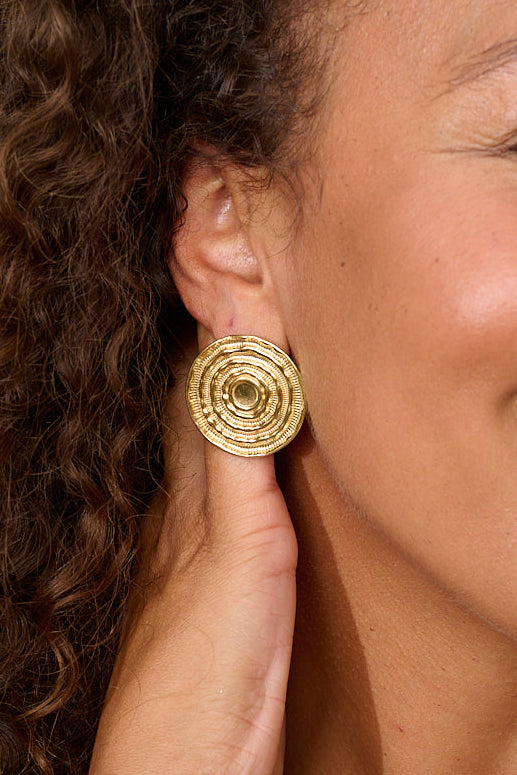 Solanda Organic Round Gold Stud Earrings worn with pulled-back hair and layered Boho Betty gold jewelry.