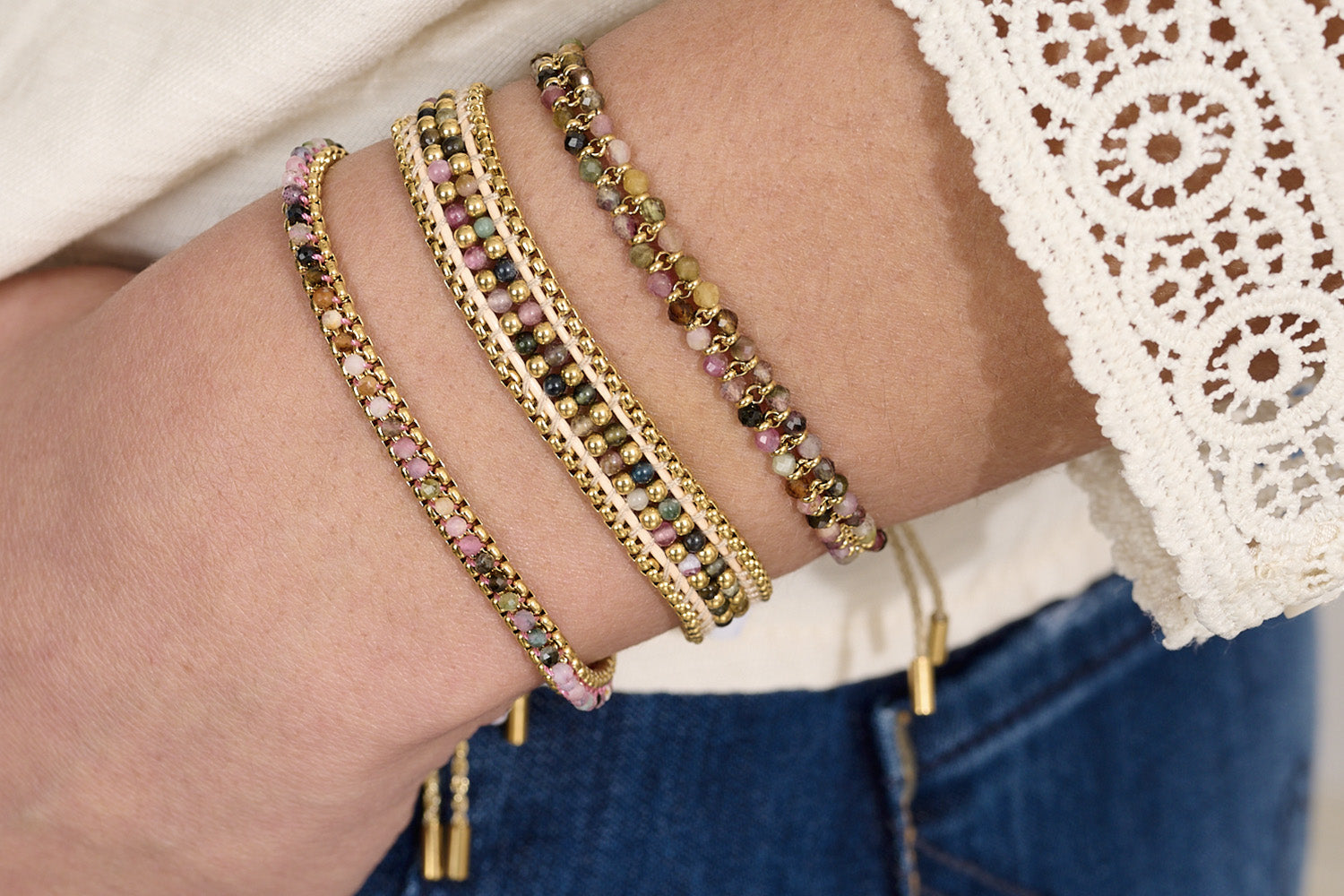 Talia Rainbow Tourmaline Gold Bracelet styled on the wrist, showcasing vibrant gemstone beads and shimmering gold accents—perfect for stacking or wearing solo.